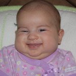 Gotta love her chubby cheek smile!